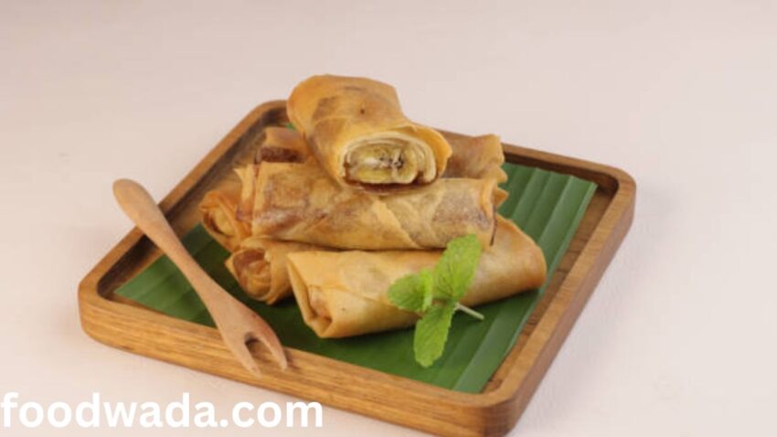 Veg spring roll in a wooden plate with dhniya and spoon