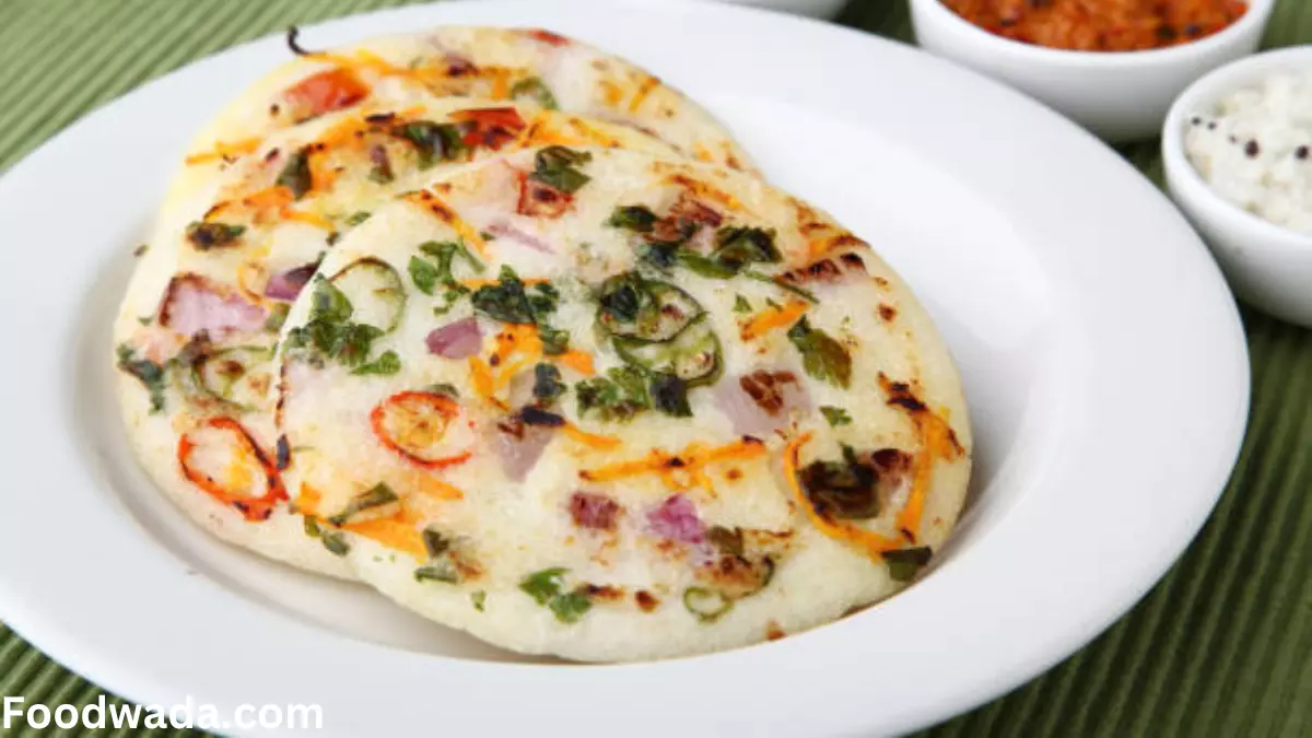 Onion uttapam food recipe in a white plate